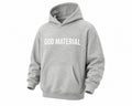 God Material grey fleece hoodie for kids with a drop shoulder design, front pocket, and white brand logo on chest.